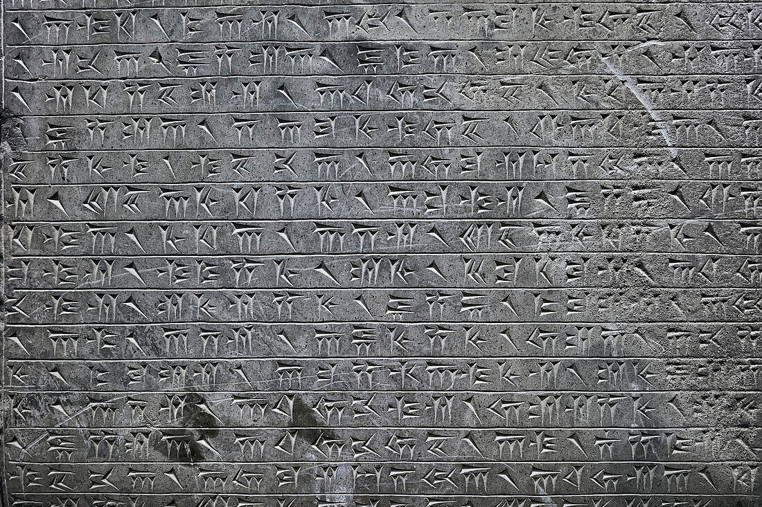 Cuneiform inscriptions on a stone displayed in Persepolis Museum, Iran.