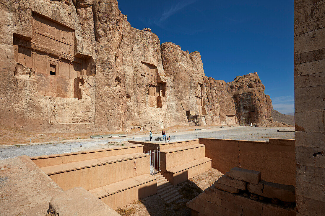 View of the Naqsh-e Rostam Necropolis, low rocky hill (aka Hossein mountain) with rock-cut tombs of kings of Achaemenian dynasty near Persepolis, Iran.