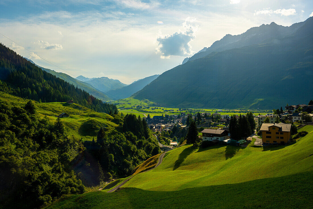 Beautiful Panoramic View over Old Cityscape and Golf Course with Mountainscape and Mountain Valley in a Sunny Summer Day in Andermatt, Uri, Switzerland.