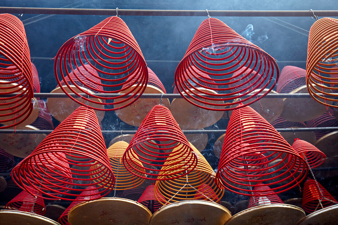 Burning incense spirals hang from ceiling in the Tin Hau Temple Complex. Yau Ma Tei, Kowloon, Hong Kong, China.