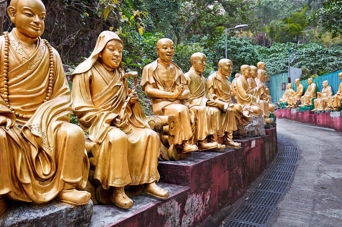 Statues of arhats (Buddhist equivalent of saints) on the way up to Ten Thousand Buddhas Monastery (Man Fat Sze). Sha Tin, New Territories, Hong Kong, China.