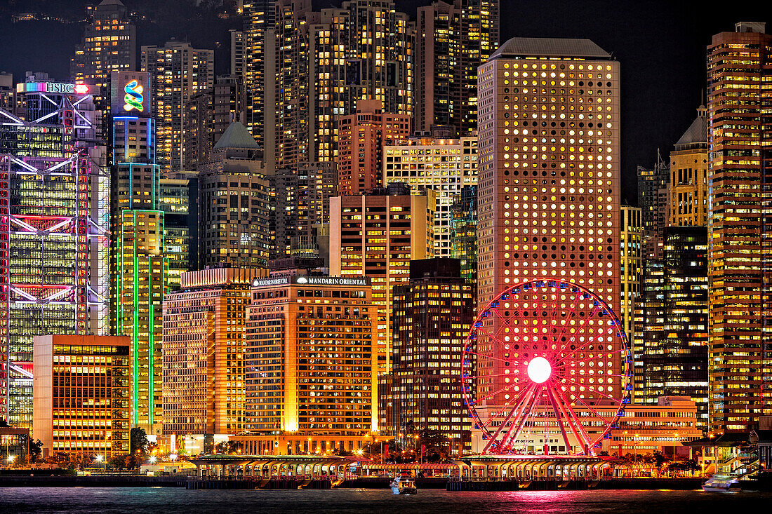 Close up view of the modern high-rise buildings at Central Waterfront illuminated at night. Hong Kong, China.