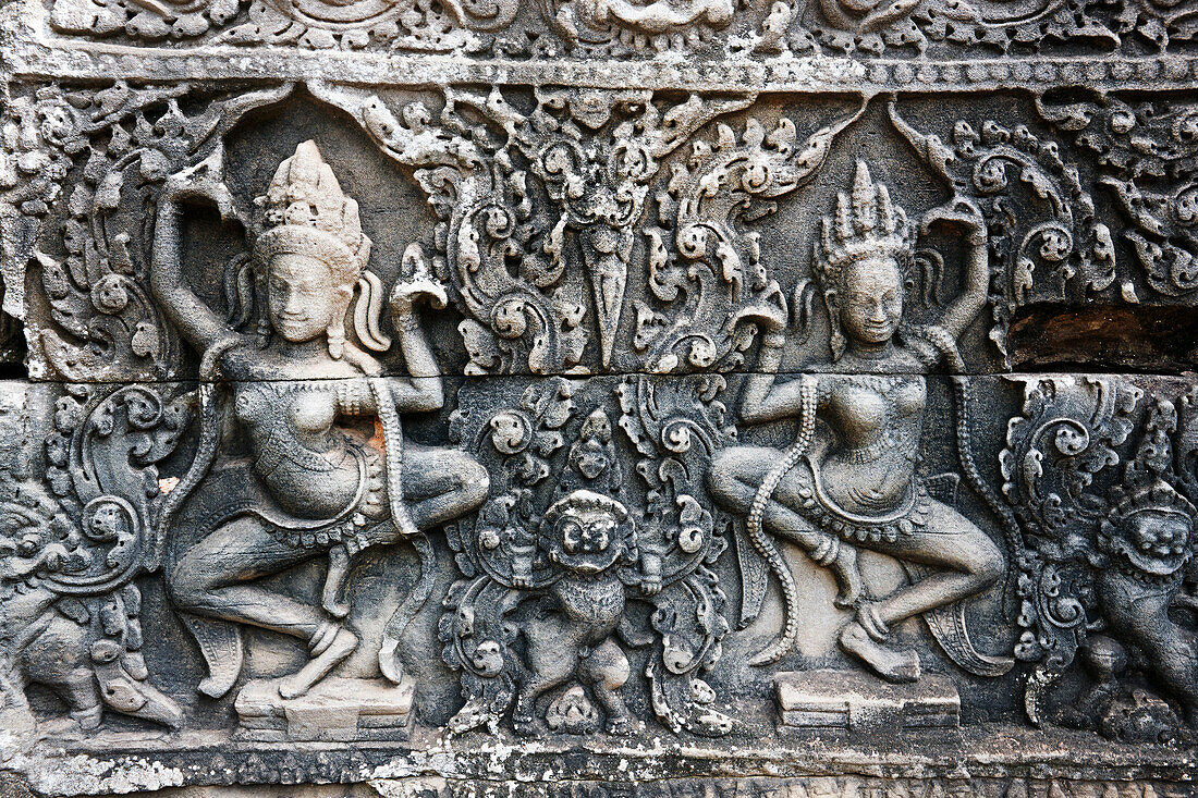 Bas-relief of apsaras (celestial dancers) in the ancient Bayon temple. Angkor Archaeological Park, Siem Reap Province, Cambodia.