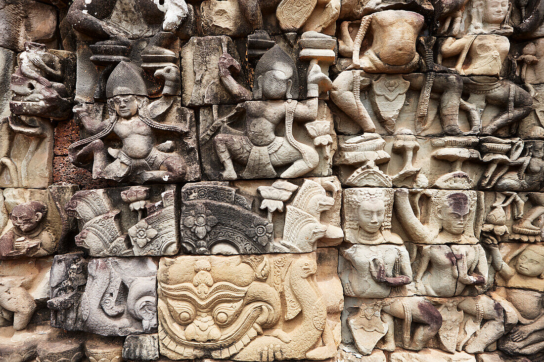 A fragment of intricate relief on the Terrace of the Elephants in Angkor Thom temple complex. Angkor Archaeological Park, Siem Reap Province, Cambodia.