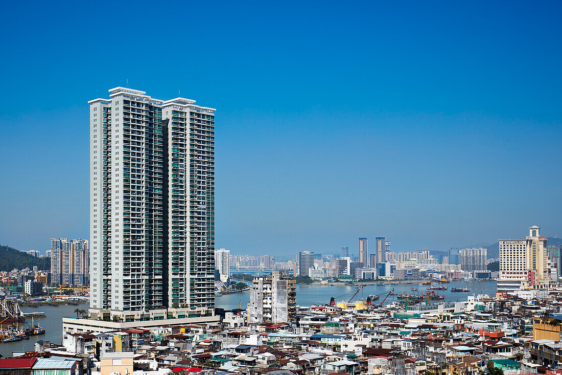 Elevated view of Macau city from the Penha Hill with Zhuhai city visible in the background. Macau, China.