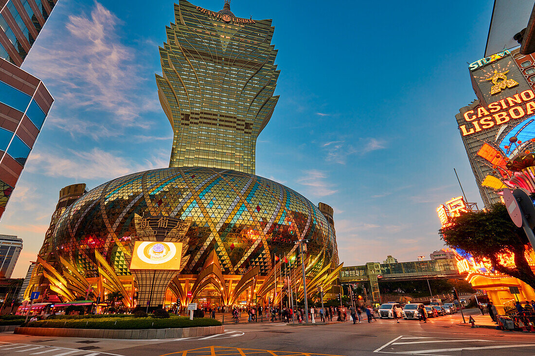 Colourful building of the Hotel Grand Lisboa illuminated at dusk. Macau, China.