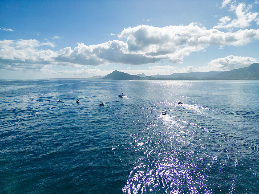  Aerial view of tour boats in the sea during a whale and dolphin watching tour with coastline in the distance, Le Morne, Rivière Noire, Mauritius, Indian Ocean 