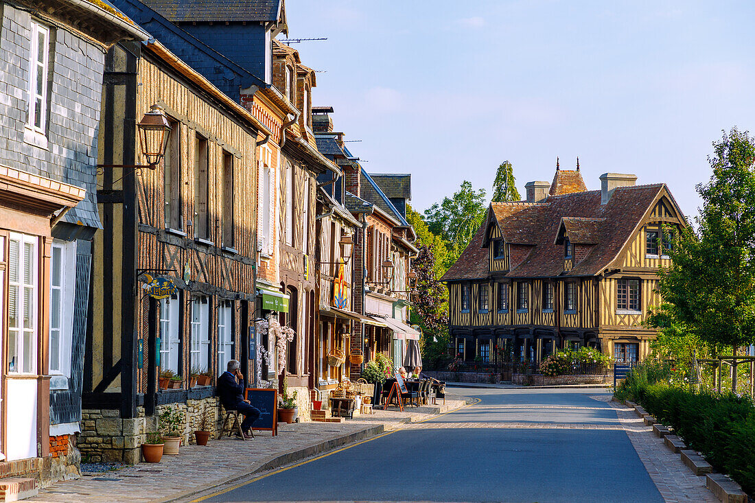  Main street with half-timbered houses in Beuvron-en-Auge in the Pays d&#39;Auge in the Calvados department in the Normandy region of France 