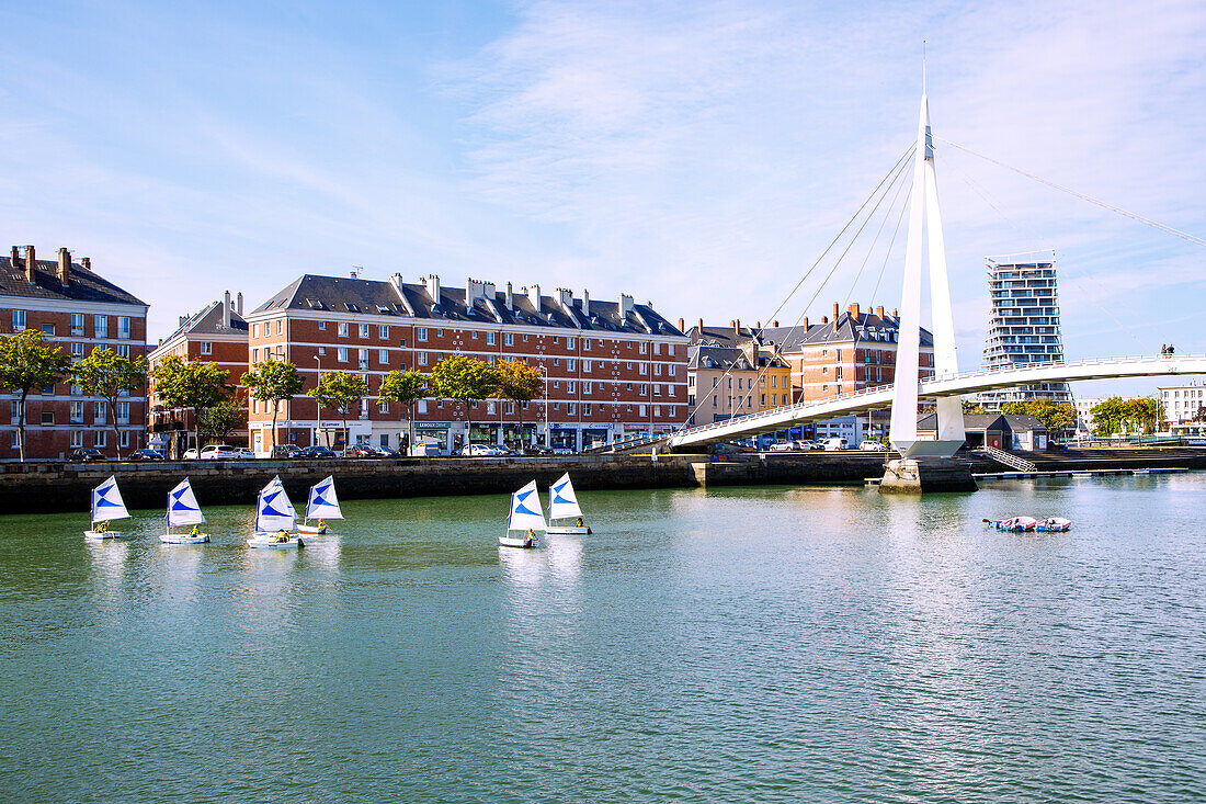  Bassin du Commerce with pedestrian bridge Passerelle de la Bourse and training boats of the sailing school, view of apartment blocks by Auguste Perret and rotated Alta Tower by the architectural firm Hamonic Masson 