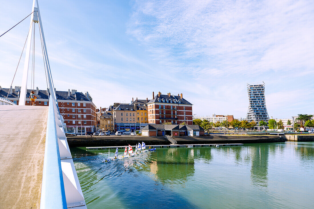  Bassin du Commerce with pedestrian bridge Passerelle de la Bourse and training boats of the sailing school, view of apartment blocks by Auguste Perret and rotated Alta Tower by the architectural firm Hamonic Masson 