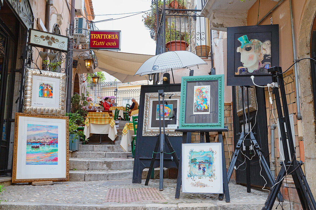 Old town street filled with artwork, Taormina, Sicily, Italy