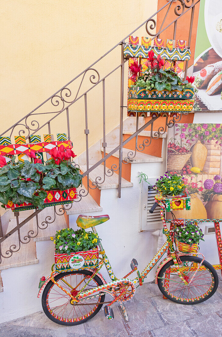 Old town alley filled with artwork, Taormina, Sicily, Italy