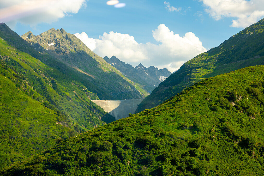 Beautiful of View over Water Dam, Staudamm in a Mountain Valley in a Sunny Summer Day in Tschamut, Lai da Curnera, Oberalp, Grisons, Switzerland.