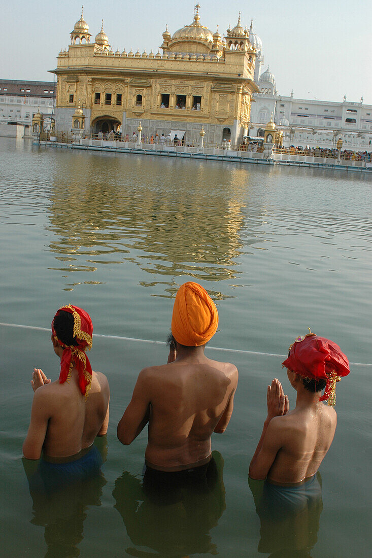 People bathing in pond, golden temple, amritsar, punjab, india, asia