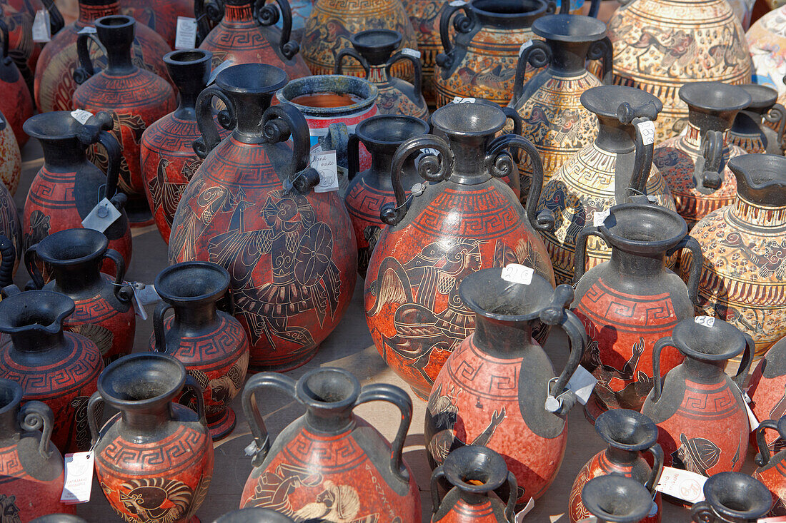 A selection of replicas of ancient Greek amphorae displayed at an outdoor pottery market. Crete, Greece.