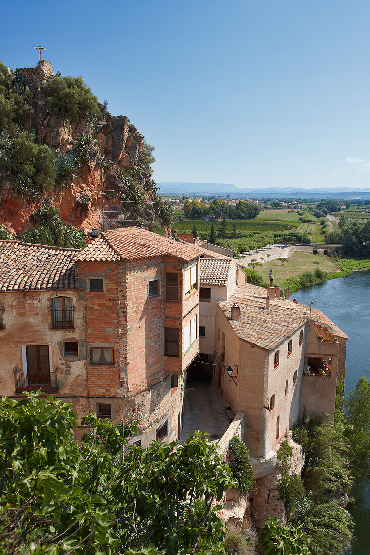 Old houses in Miravet village with Ebro river running below. Miravet, Catalonia, Spain.