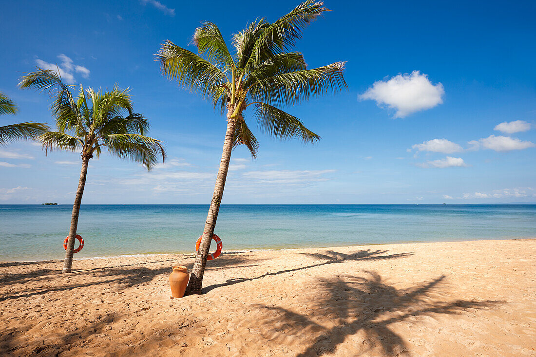 Sandy beach with palm trees at the Vinpearl Resort on Phu Quoc island, Vietnam.