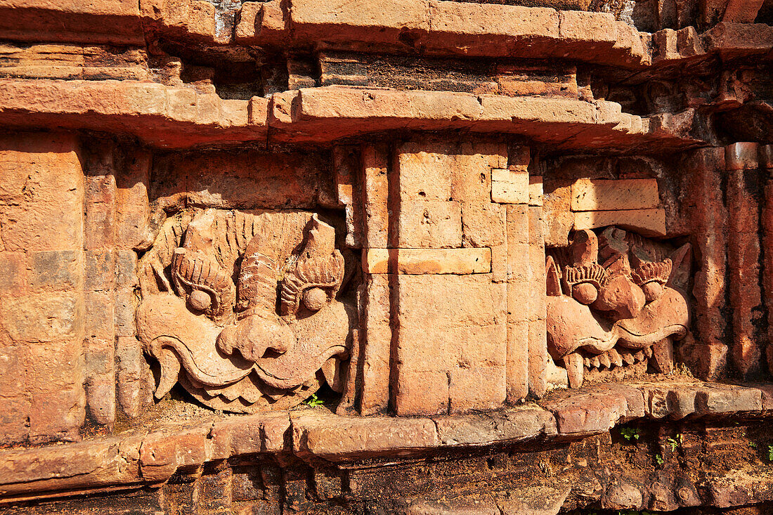 Kirtimukha (Kala) faces on an ancient temple in Group G. My Son Sanctuary, Quang Nam Province, Vietnam.