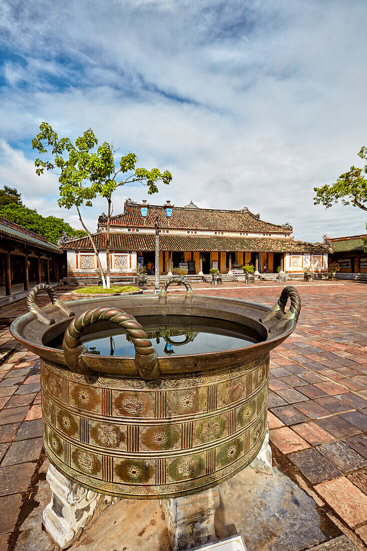 A massive bronze cauldron filled with water at the Can Chanh Palace (Palace of Audiences). Imperial City, Hue, Vietnam.