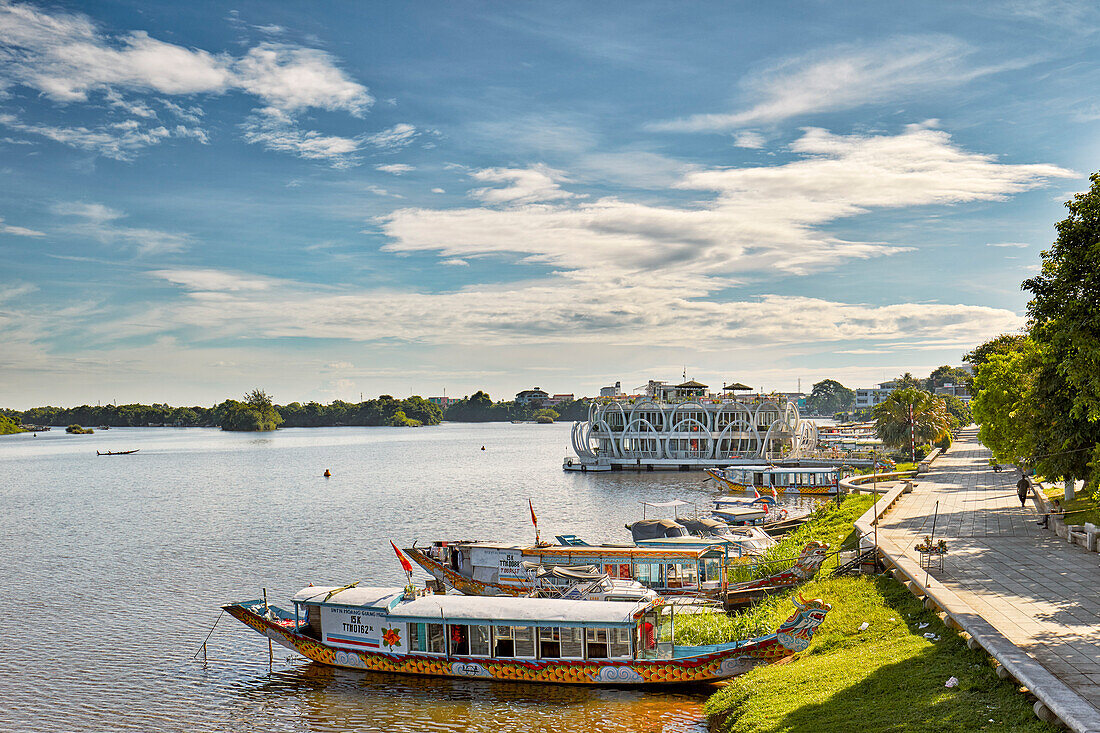 Dragon boats moored at the bank of Perfume River. Hue, Vietnam.