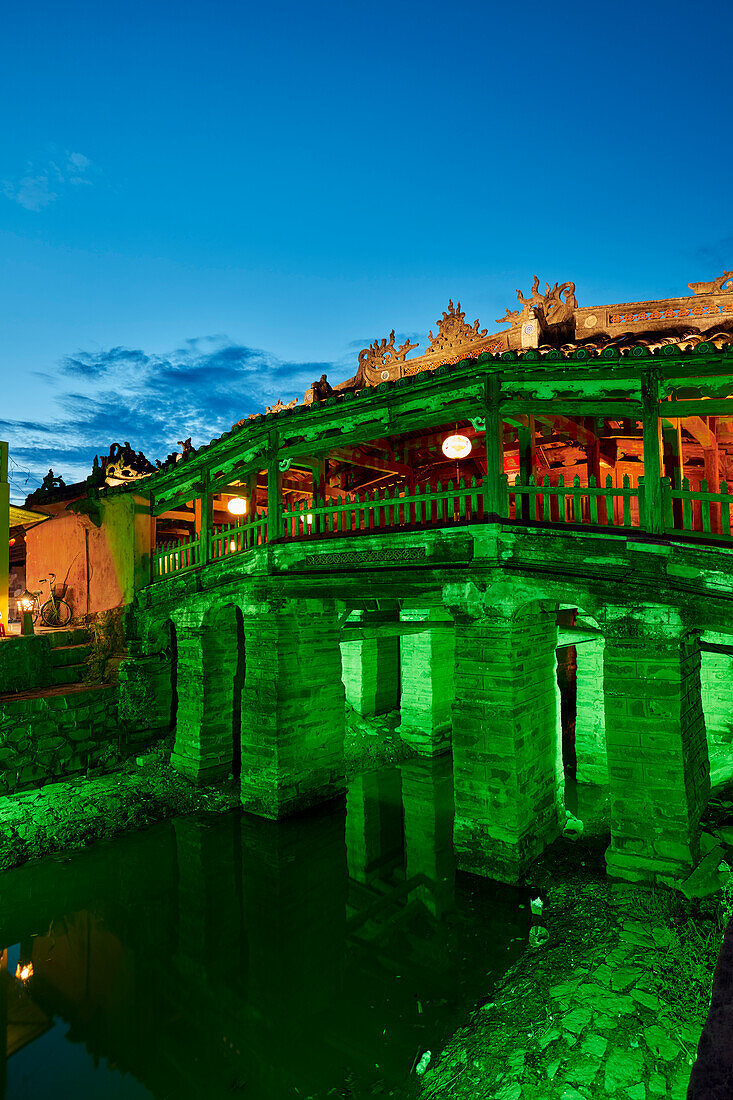 Exterior view of the Japanese Covered Bridge illuminated at dusk. Hoi An Ancient Town, Quang Nam Province, Vietnam.