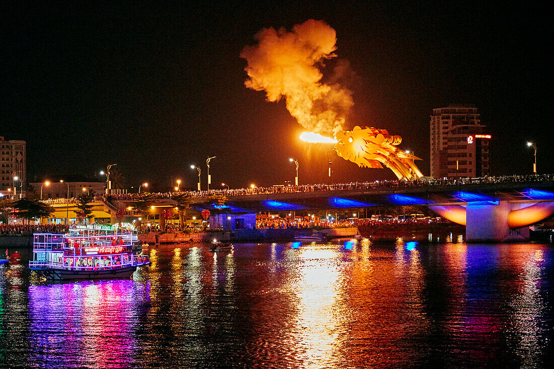 Dragon head on the Dragon Bridge (Cau Rong) breathes fire at night. Da Nang city, Vietnam.