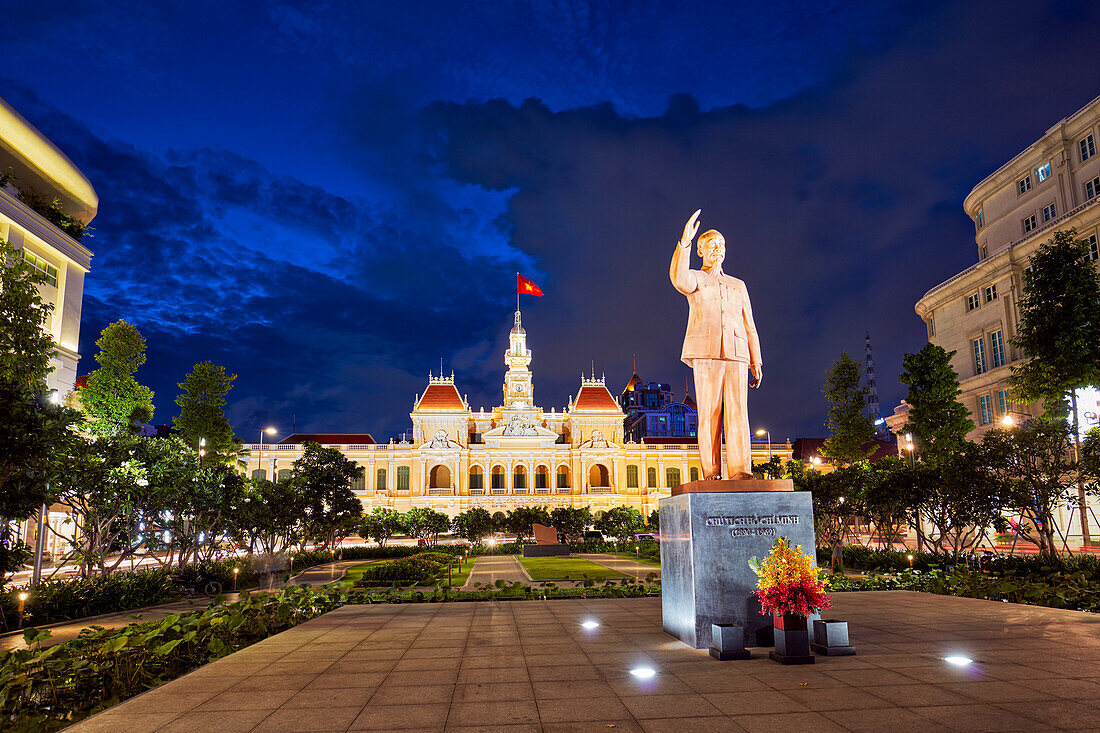 Ho Chi Minh monument and People’s Committee Building illuminated at dusk. District 1, Ho Chi Minh City, Vietnam.