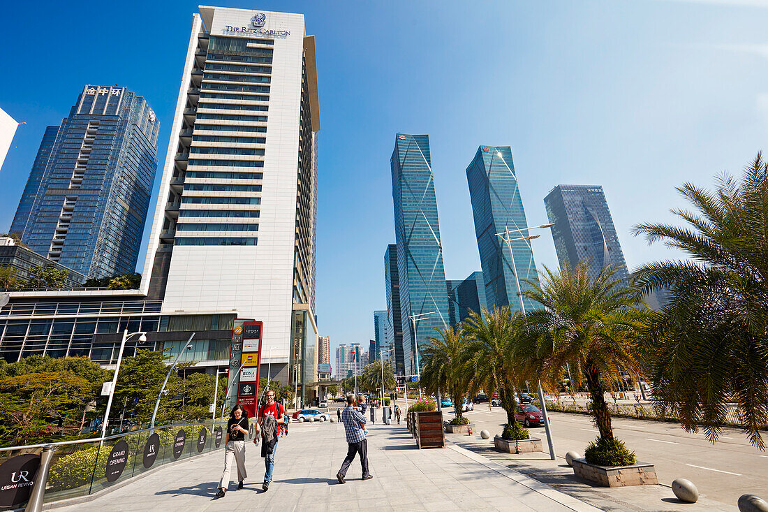 Menschen gehen auf Gehweg im zentralen Geschäftsviertel (CBD) von Futian. Shenzhen, Provinz Guangdong, China.