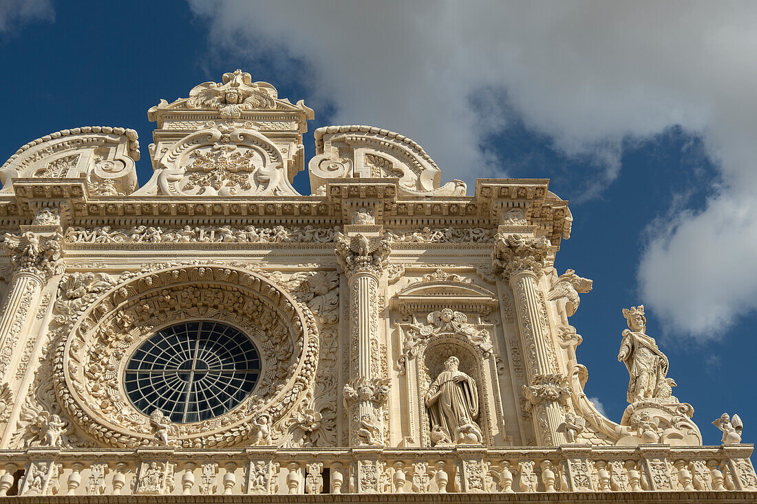 Detail of the richly decorated façade of the Basilica di Santa Croce in Lecce, Puglia, Italy.