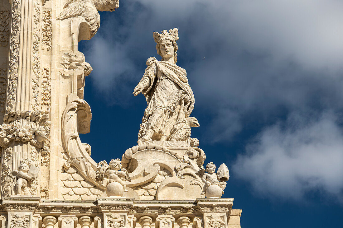 Detail of the richly decorated façade of the Basilica di Santa Croce in Lecce, Puglia, Italy.