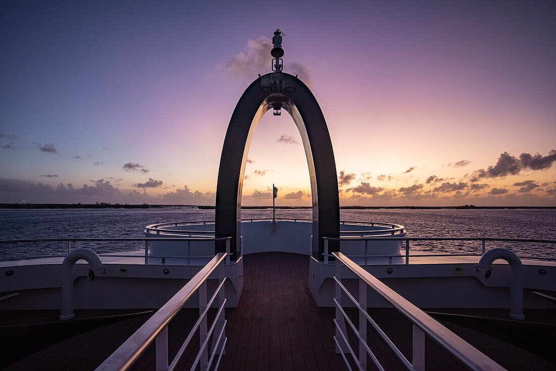  Crow&#39;s nest on the bow of the expedition cruise ship SH Diana (Swan Hellenic) with Aldabra on the horizon at dawn, Aldabra Atoll, Outer Seychelles, Seychelles, Indian Ocean 