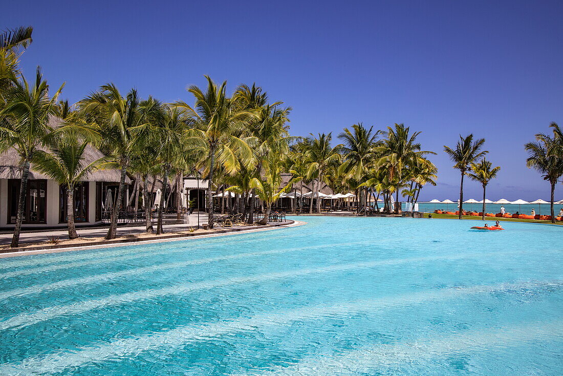 Swimming pool and coconut palm trees at Dinarobin Beachcomber Golf Resort & Spa (Beachcomber Resorts), Le Morne, Rivière Noire, Mauritius, Indian Ocean