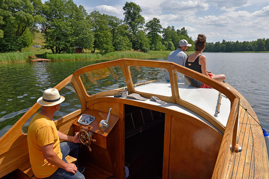 wooden motorboat trip along the lakes around Paluse, Aukstaitija National Park, Lithuania, Europe