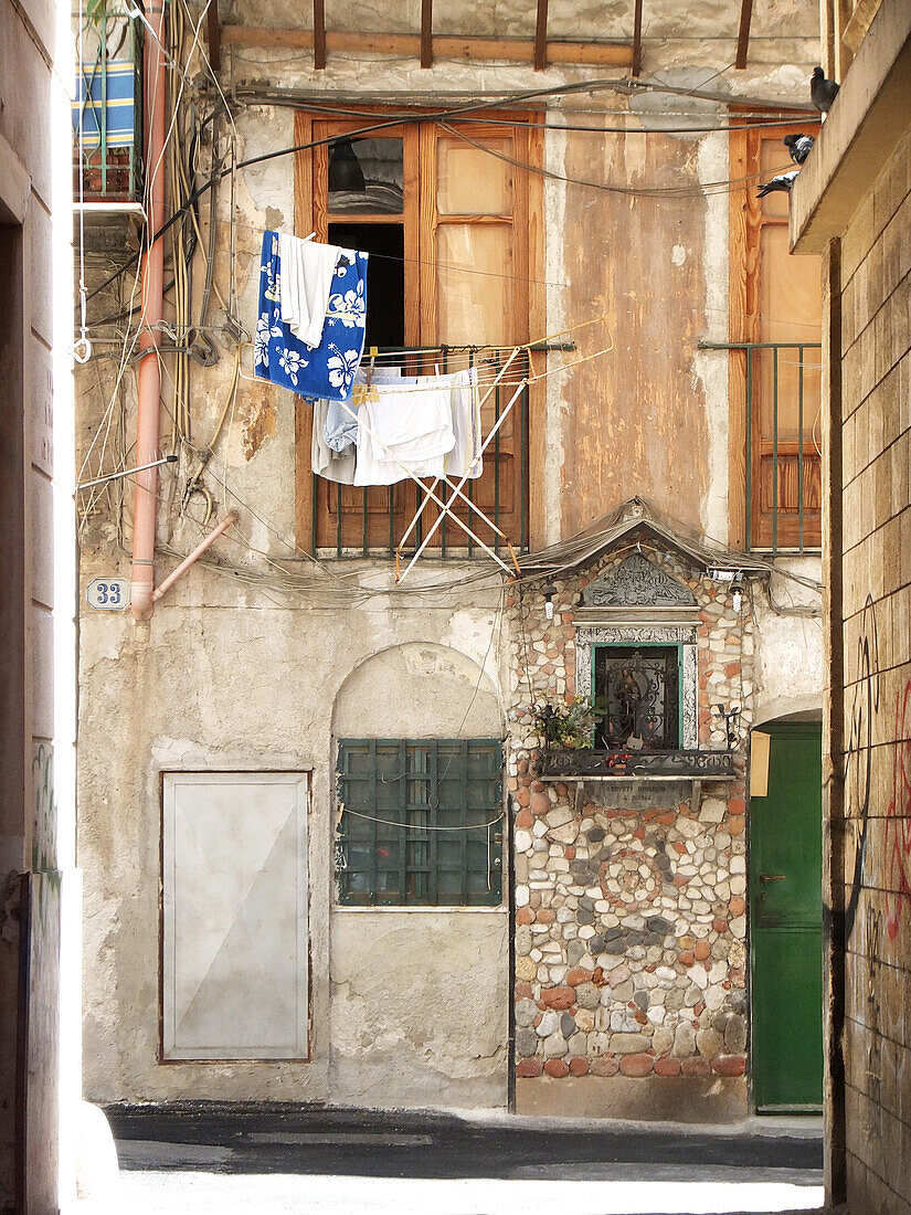  Clothes rack in front of a window in an alley in Palermo, Sicily, Italy, Europe 