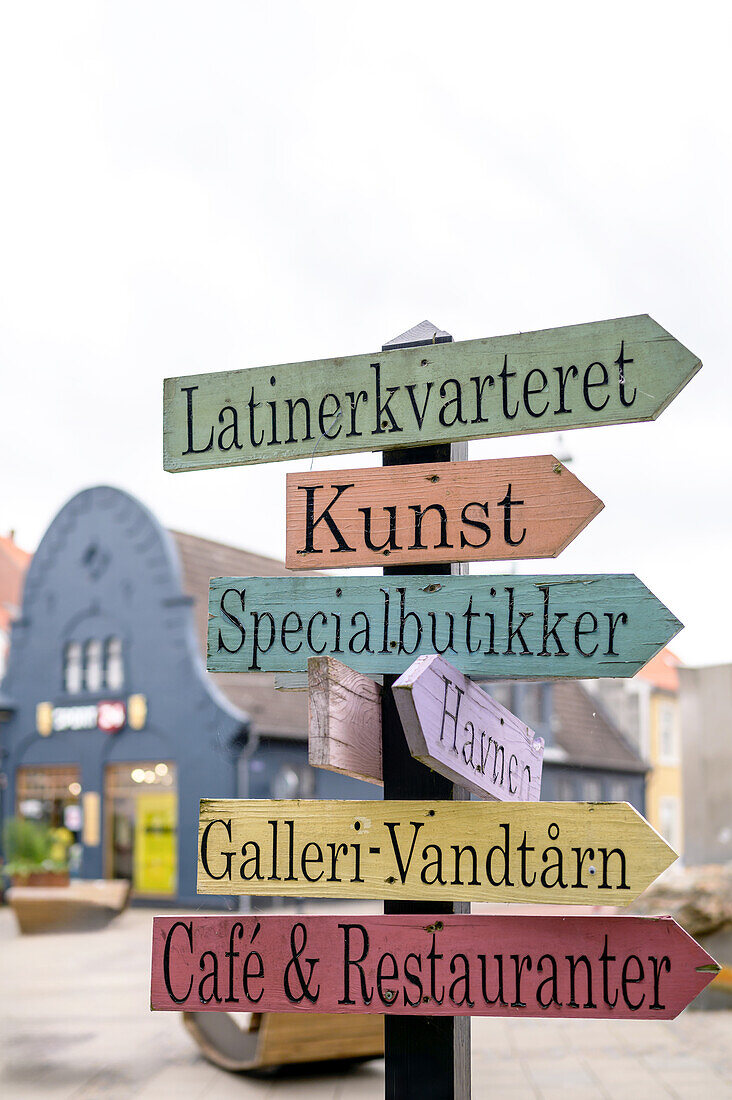  Colorful wooden signs in the pedestrian zone of Nyköbing, Falster, Denmark, Europe 