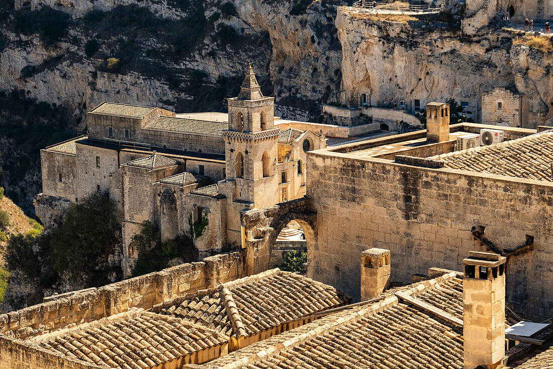 Saint Peter and Saint Paul Church (San Pietro Caveoso) with the Murgia Materana park (Parco della Murgia Materana) in the background, Matera, Basilicata, Italy.