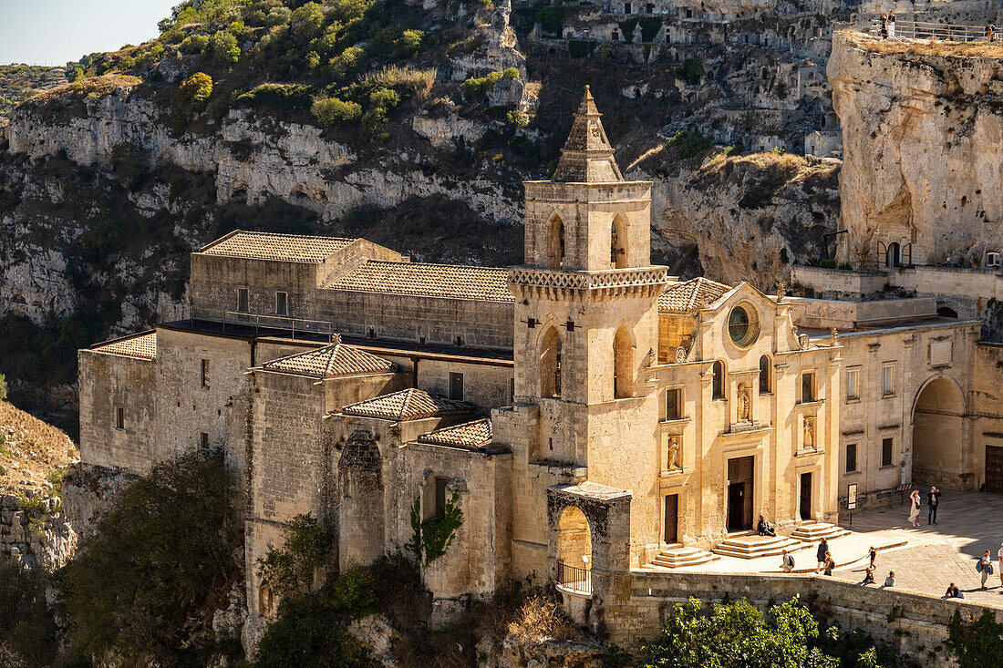 Saint Peter and Saint Paul Church (San Pietro Caveoso) with the Murgia Materana park (Parco della Murgia Materana) in the background, Matera, Basilicata, Italy.