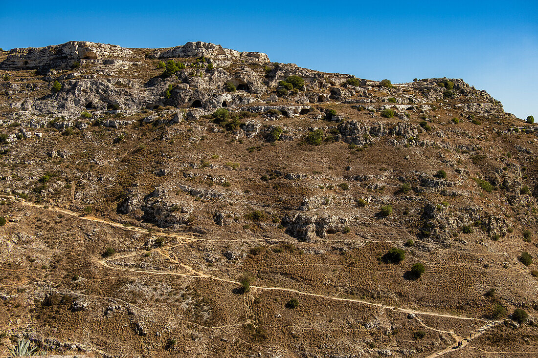 Ancient cave dwellings on the side of the Murgia Materana park (Parco della Murgia Materana), Matera, Basilicata, Italy.