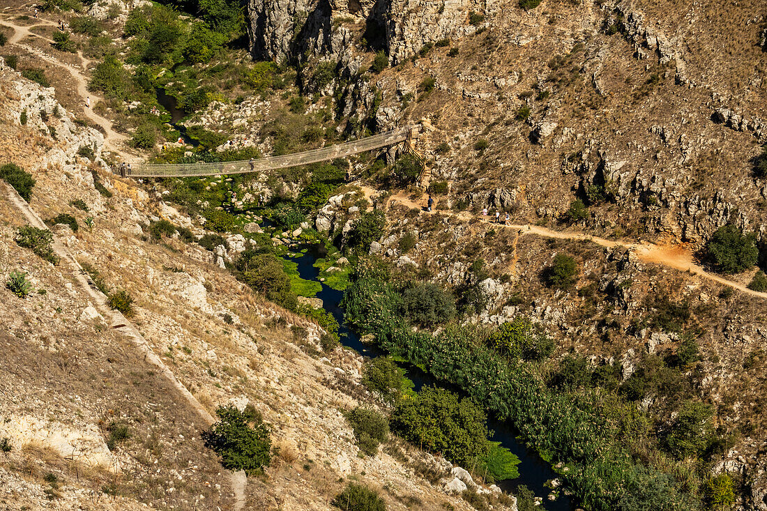 People hiking in the Murgia Materana park (Parco della Murgia Materana), Matera, Basilicata, Italy.