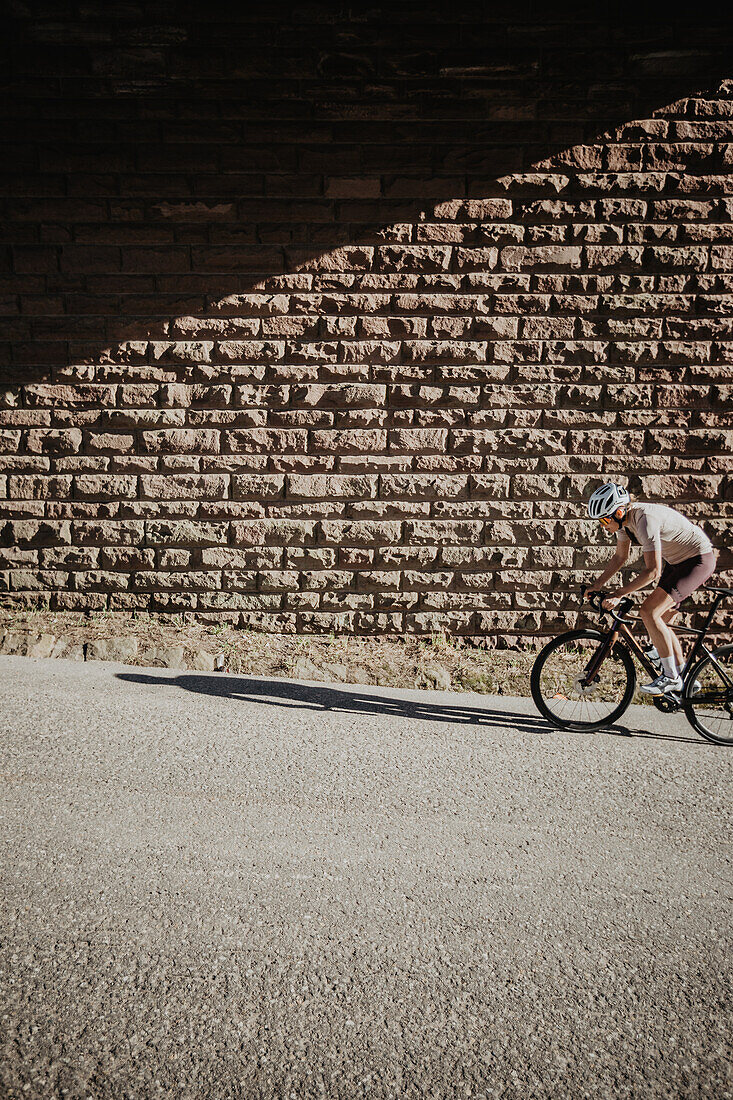 Road biking, woman riding a racing bike on the road