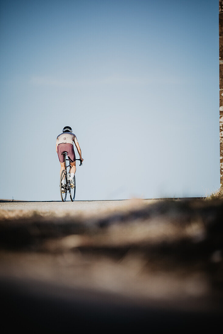 Road biking, woman riding a racing bike on the road