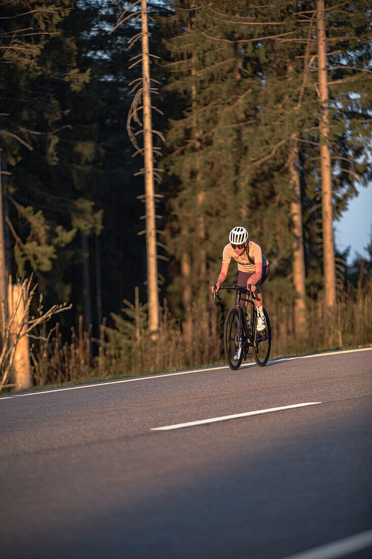 Roadbiken, Frau beim Rennrad fahren auf der Straße