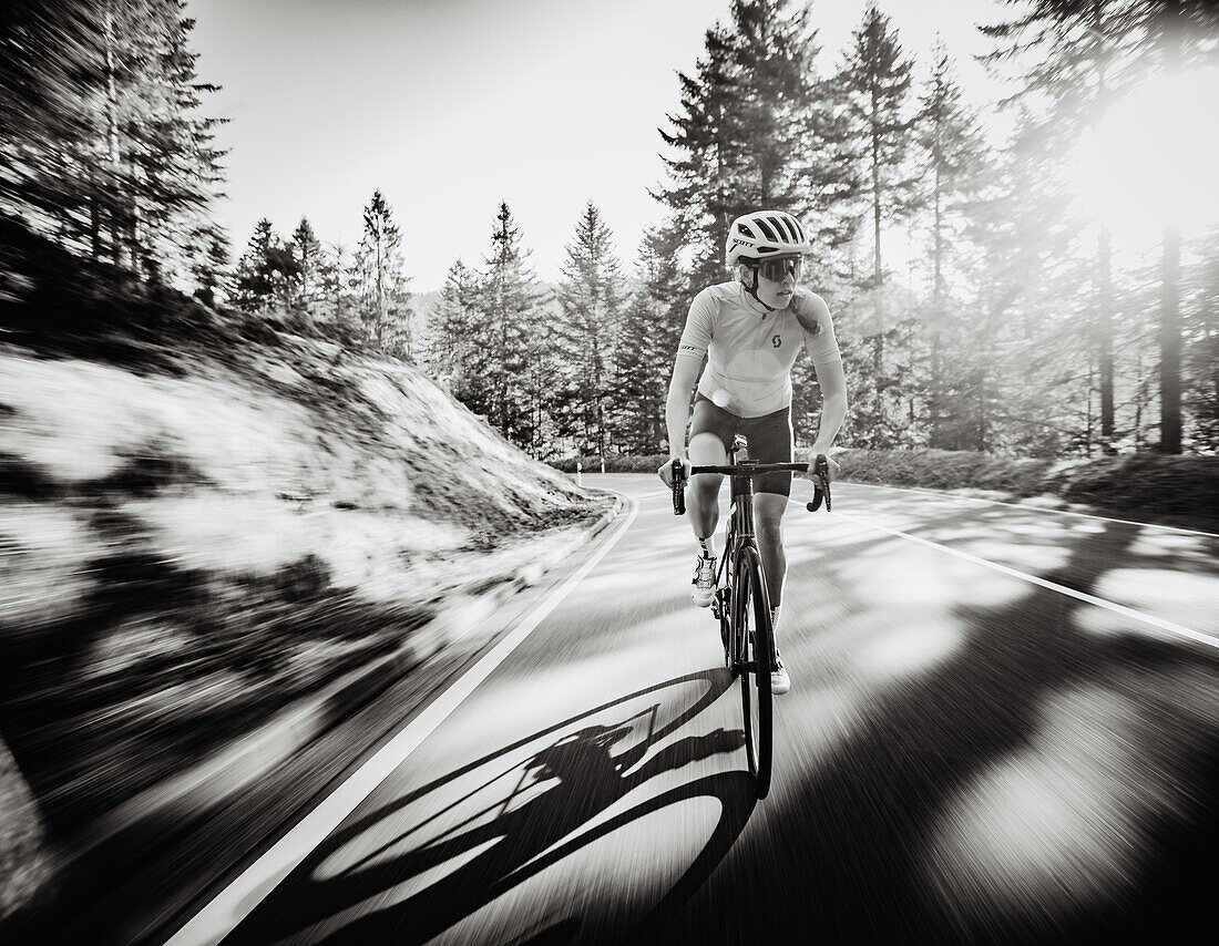 Road biking, woman riding a racing bike on the road