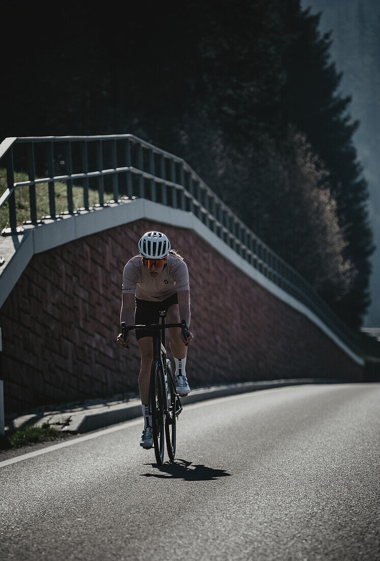 Road biking, woman riding a racing bike on the road