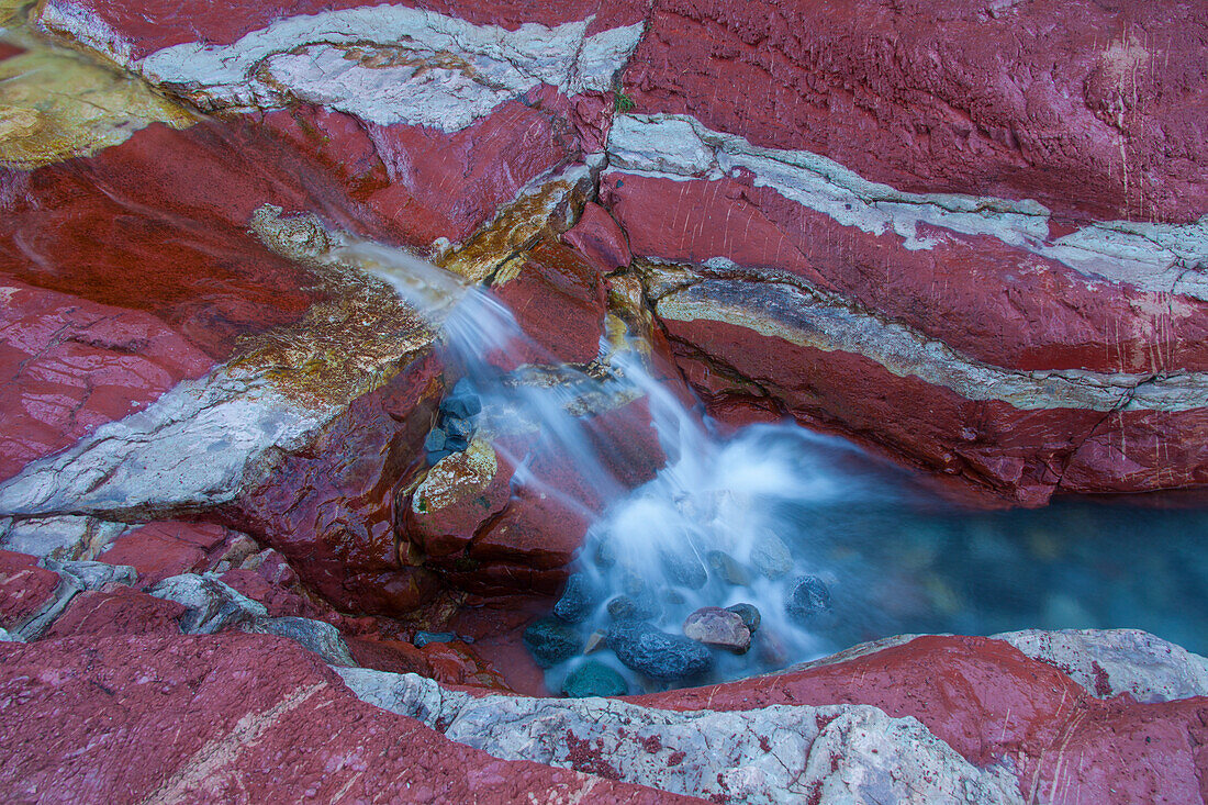  Stream flows through iron-rich rock, Red Rock Canyon, Waterton Lakes National Park, Alberta, Canada 