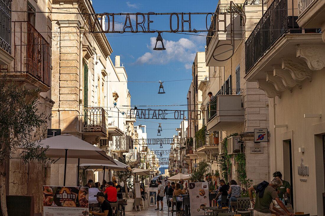  The lyrics of the song VOLARE Nel blu dipinto di blu as lighting over the pedestrian zone Via Roma, Polignano a Mare, Apulia, Italy, Europe 