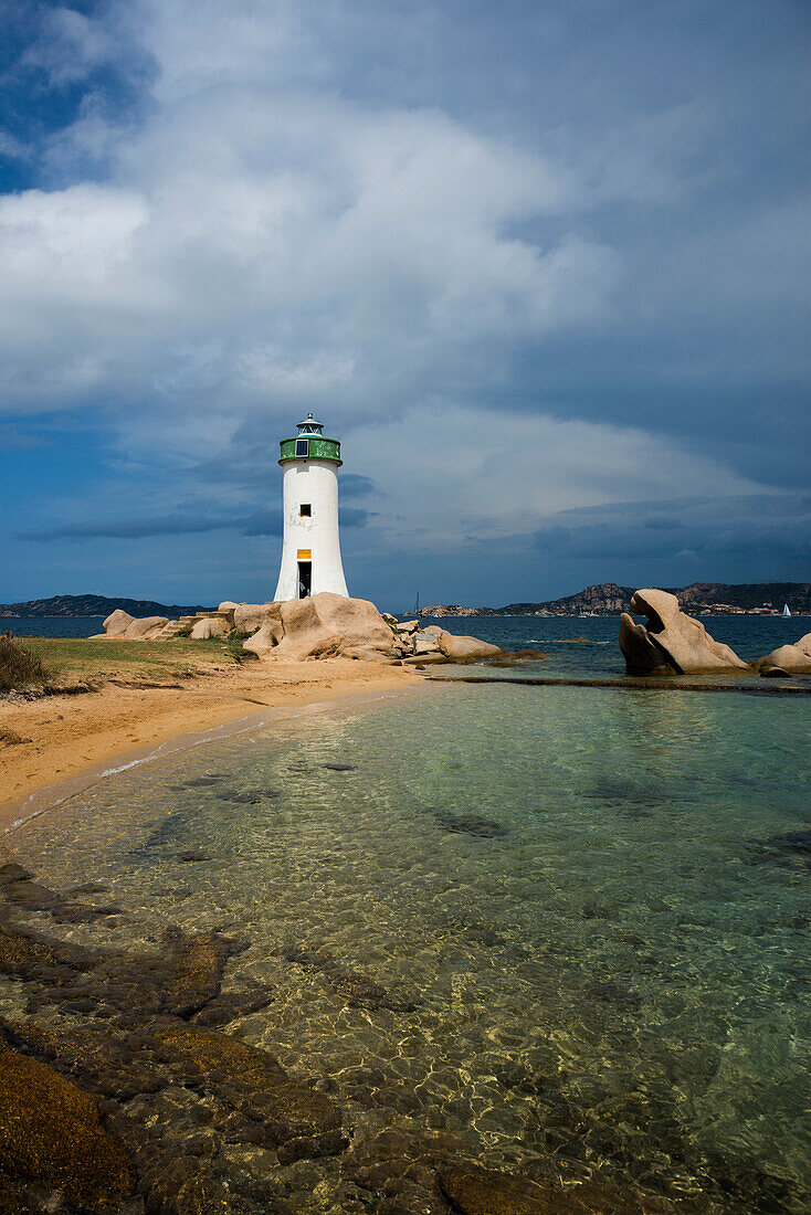  Lighthouse with beach and bizarre granite rocks, Spiaggia Porto Faro, Faro di Punta Palau, Palau, Costa Smeralda, Sardinia, Italy 