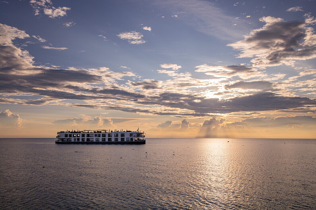  River cruise ship RV Mekong Discovery (Thurgau Travel) on Tonle Sap Lake at sunset, Chong Khneas, near Siem Reap, Siem Reap Province, Cambodia, Asia 