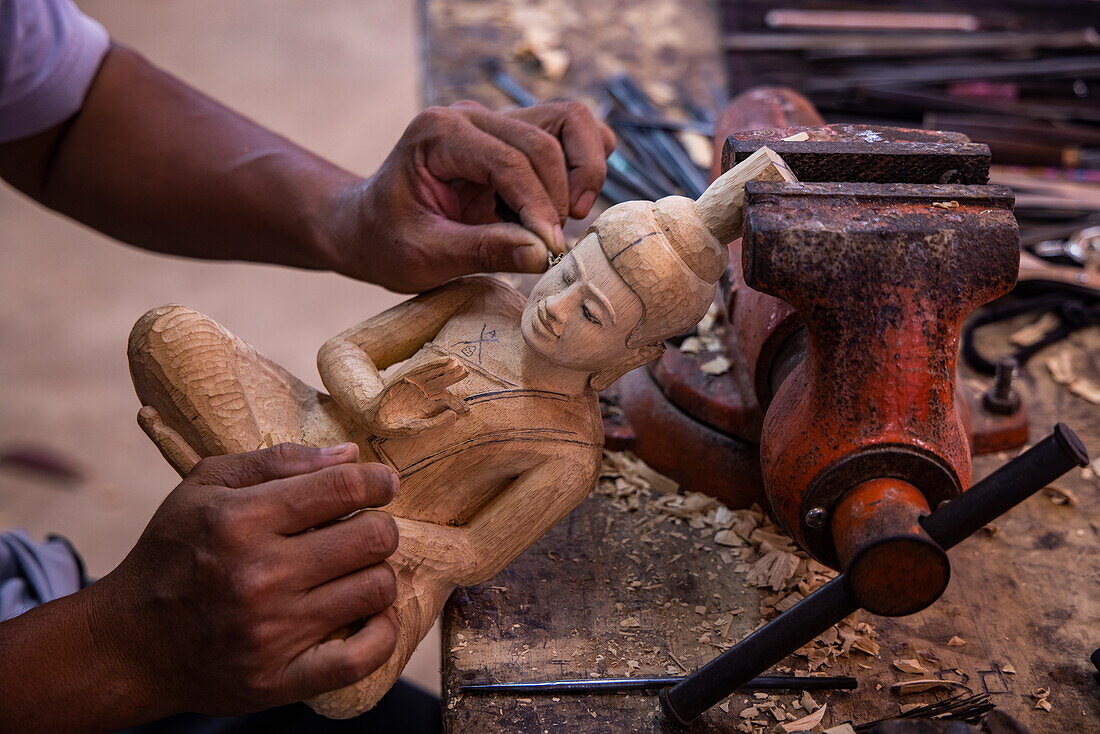  Detail of a wooden Buddha figure being carved at Angkor Artisans handicraft and souvenir shop, near Siem Reap, Siem Reap Province, Cambodia, Asia 