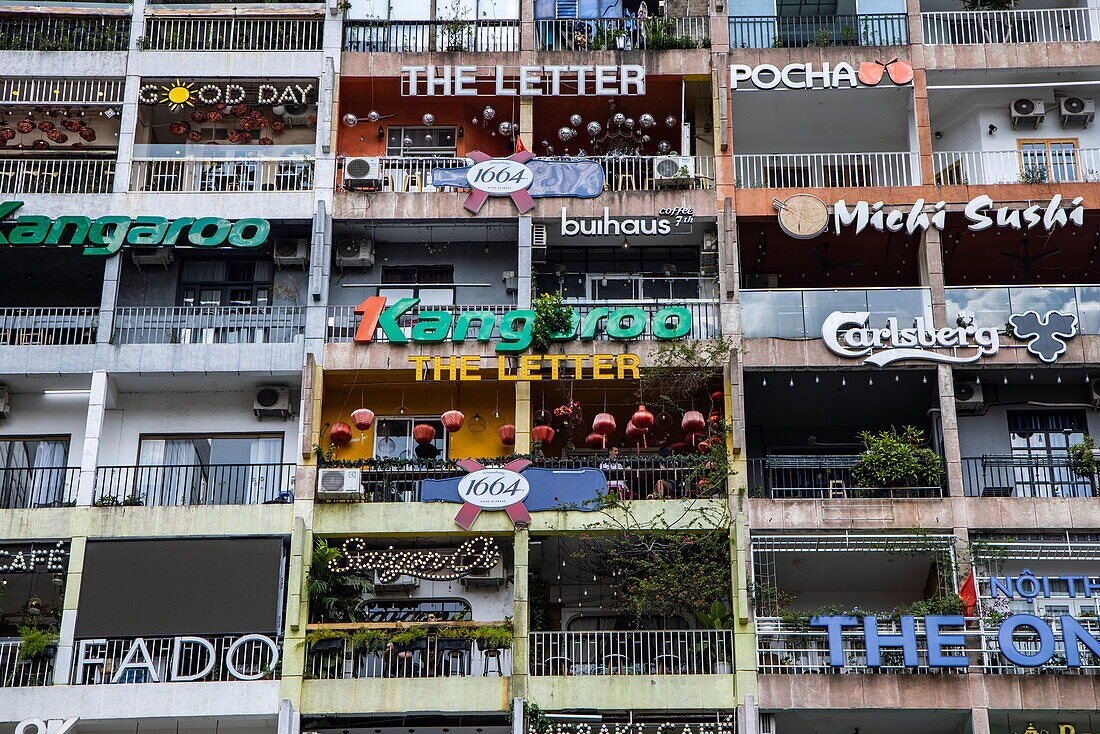  High-rise building with many advertising signs in the city center, Ho Chi Minh City, Vietnam, Asia 